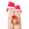 Fingers faces in Santa hats with gift box. Happy couple concept