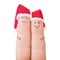 Fingers faces in Santa hats. Happy couple celebrating concept