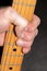 Fingers on the fretboard of a Telecaster electric guitar