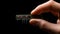 Fingers Grasping Cutting-Edge Microchip - A Glimpse into Tomorrow\\\'s Tech