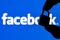 Fingers hold a closed security lock on the background of the facebook social network logo. The concept of data security in Faceboo