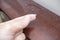 Fingers holding dust from wooden polished surface of furniture, dusty home concept