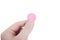 Fingers holding pink pill