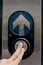 Fingers pressing traffic light button with up arrow