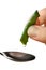 Fingers squeezing fresh juice out of a aloe vera into spoon