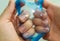 Fingers stretch the transparent blue slime close-up. Beautiful female hands are playing with a popular anti-stress toy called slim