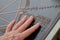 Fingers touching braille tourist map