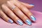 Fingers of a young woman\\\'s hand with beautiful pearlescent nail polish, Creative manicure