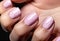 Fingers of a young woman\\\'s hand with beautiful pearlescent nail polish, Creative manicure