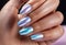 Fingers of a young woman\\\'s hand with beautiful pearlescent nail polish, Creative manicure