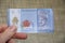fingertips holding plastic banknote of one 1 Malaysian Ringit, the national currency of Malaysia,
