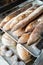 Finished French bread in the bakery on the racks. Baguettes, rustic bread, crown of kings Bordeaux.