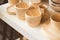 Finished hand-painted clay products lie on a shelf in a pottery workshop