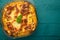 Finished Italian Lasagna, on a green wooden background. Top view with space for design