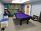 Finished pool table in basement game room