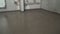 The finished result, the solution is aligned on the floor. Builders leveled the floor with a mortar and a mixture. Fill screed