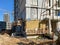 Finishing the facade of a monolithic building made of concrete and gas silicate blocks with mineral wool insulation during the