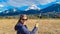 Finkenstein - Woman holding pussy willows in spring with scenic view of majestic snow capped mountain peak Mittagskogel