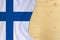 Finland country colored silk national flag, empty wooden mocap for text, concept of tourism, travel, emigration, global business,