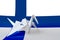 Finland flag depicted on paper origami crane wing. Handmade arts concept