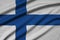 Finland flag is depicted on a sports cloth fabric with many folds. Sport team banner