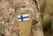 Finland flag on soldiers arm collage