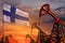Finland oil industry concept. Industrial illustration - Finland flag and oil wells with the red and blue sunset or sunrise sky