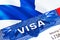 Finland Visa in passport. USA immigration Visa for Finland citizens focusing on word VISA. Travel Finland visa in national
