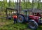 Finland/Wood logging: Tractor with Hydraulic Grabber Lifting Timber