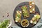 Finn crisp with microgreens, tofu, sprouts and cucumber slices. Top view. On a black plate, with pomegranate seeds, a