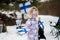 Finnish baby girl with Finland flags on a nice winter day. Nordic Scandinavian people