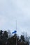 Finnish flag lowered to half mast on the occasion of mourning at cloudy autumn day