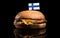 Finnish flag on top of hamburger isolated on black