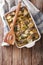 Finnish Food: Casserole with potatoes and herring close up in ba