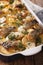 Finnish Food: Casserole with potatoes and herring close up in ba