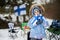Finnish little girl with Finland flags on a nice winter day. Nordic Scandinavian people