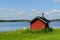 Finnish sauna on shore of blue lake