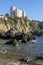 The fins of a scuba diver with the Rocca Aldobrandesca of Talamone in the background, Tuscany, Italy