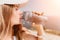 Fintess woman drinking water. Happy, active middle aged woman standing on beach and drinking water after excersise