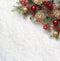 Fir branch with Christmas decorations on the background of natural snow