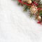 Fir branch with Christmas decorations on the background of natural snow