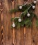 Fir branch in the corner with vintage garland on wooden background.christmas atmosphere.