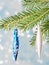 Fir tree branch with blue and white toys