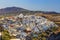 Fira town, Santorini island in Greece. Landscape with white buildings. Incredibly romantic top view of Oia village with mountai