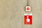 Fire alarm call point service sign label with red color push button switch on cement wall