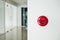 Fire alarm, emergency button on white wall in modern office