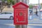 Fire alarm inside the small red house on a wooden post at crosswalk in San Francisco, California
