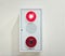 A fire alarm panel in white color with red indicator light a buzzer or speaker and an alarm button