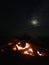 Fire on Beach during Full Moon Rising on Kauai Island, Hawaii.