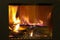 Fire behind the glass in a closed fireplace